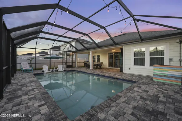 a view of a swimming pool with a table and chairs