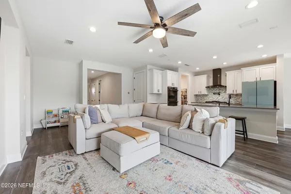 a living room with furniture and a flat screen tv