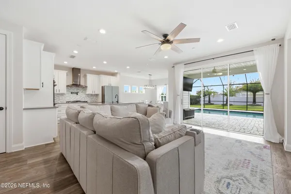 a open kitchen with stainless steel appliances granite countertop a sink and a wooden floors