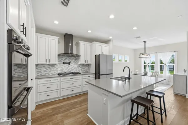 a kitchen with granite countertop a stove and cabinets
