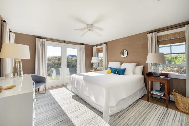 a bedroom with a large bed and a large window