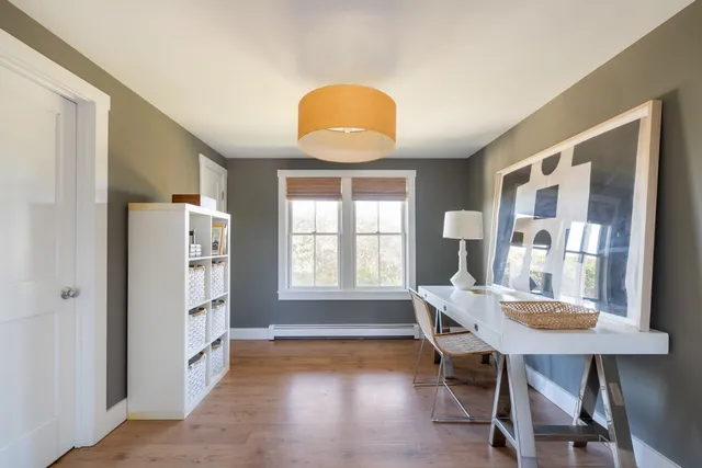 a view of a dining room with furniture and window