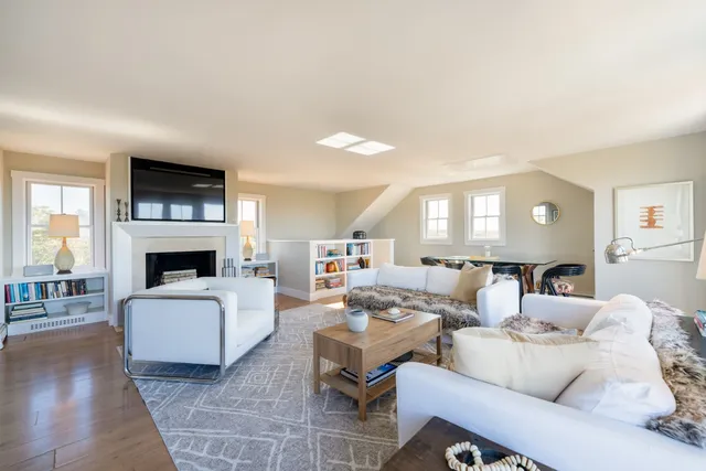 a living room with furniture a fireplace and a flat screen tv