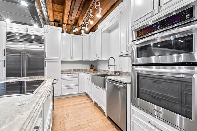 a kitchen with stainless steel appliances granite countertop a stove and a microwave