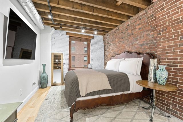 a spacious bedroom with a bed and a couch