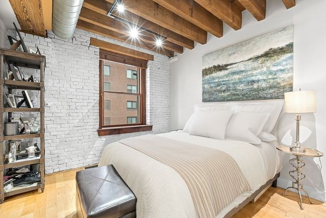 a bedroom with a bed and a night stand