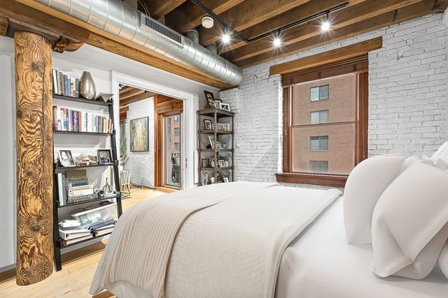 a spacious bedroom with a bed and a large mirror