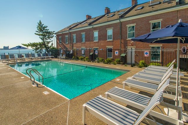 a view of a patio with chairs next to a yard