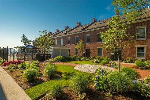 a view of backyard with plants and outdoor seating