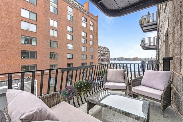 a balcony with table and chairs
