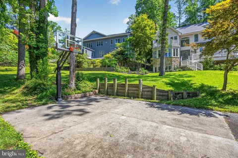 a kitchen with granite countertop a table chairs stove a sink dishwasher and cabinets with wooden floor