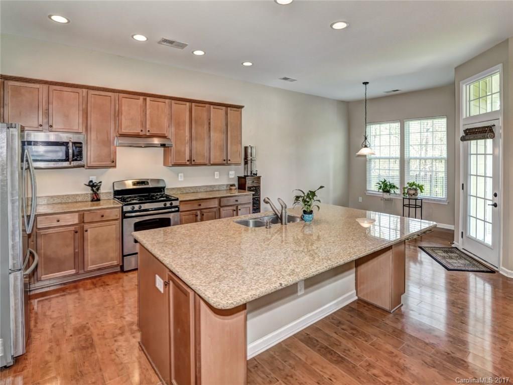 15731 Kiser Corner Lane Davidson, NC 28036 - Photo 11 of 24 a kitchen with stainless steel appliances granite countertop a stove a sink and a refrigerator