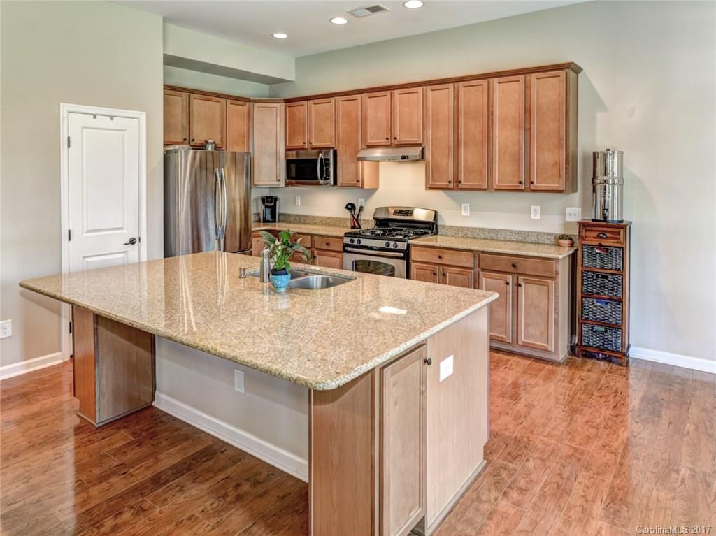 15731 Kiser Corner Lane Davidson, NC 28036 - Photo 12 of 24 a kitchen with stainless steel appliances granite countertop a sink stove microwave and refrigerator