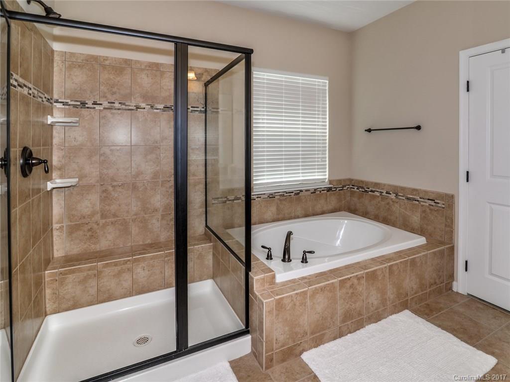 15731 Kiser Corner Lane Davidson, NC 28036 - Photo 15 of 24 a bathroom with a tub and a shower