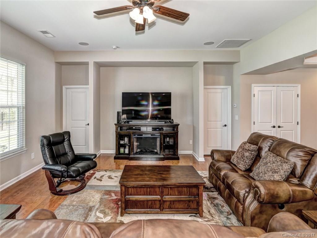 15731 Kiser Corner Lane Davidson, NC 28036 - Photo 5 of 24 a living room with furniture a flat screen tv and a window