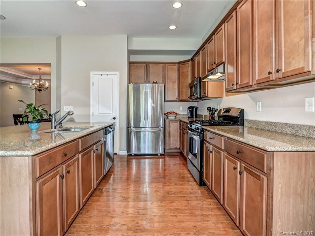 15731 Kiser Corner Lane Davidson, NC 28036 - Photo 8 of 24 a kitchen with stainless steel appliances granite countertop a refrigerator a stove and a sink