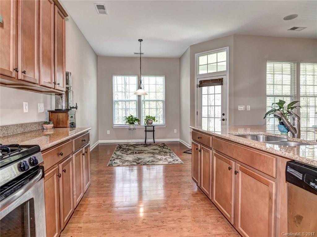 15731 Kiser Corner Lane Davidson, NC 28036 - Photo 9 of 24 a large kitchen with stainless steel appliances granite countertop a stove a sink dishwasher and cabinets with wooden floor
