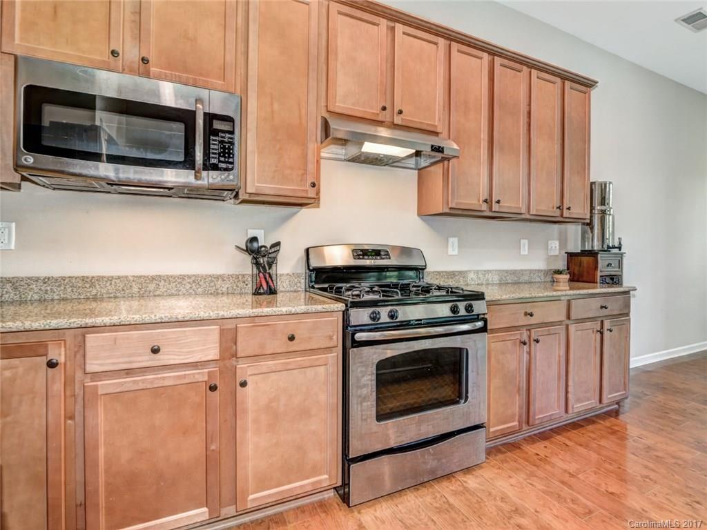 15731 Kiser Corner Lane Davidson, NC 28036 - Photo 10 of 24 a kitchen with stainless steel appliances granite countertop a stove microwave and cabinets