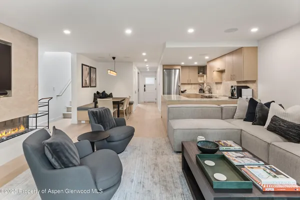 a living room with furniture and a wooden floor