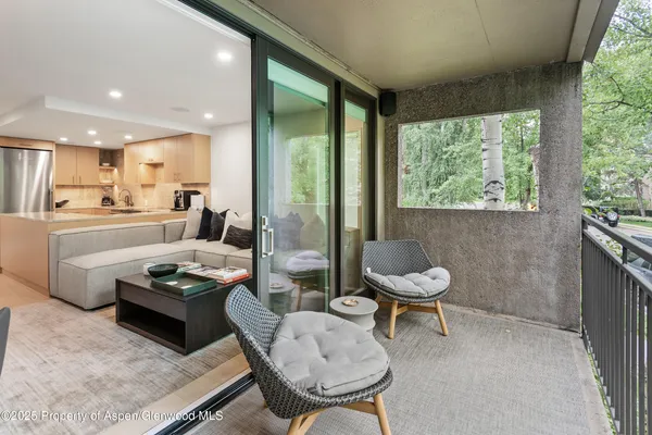 a kitchen with a table chairs a sink dishwasher and cabinets