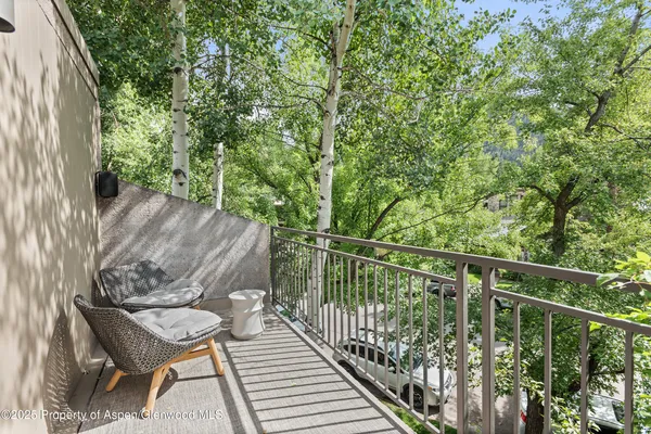 a view of a balcony with chairs