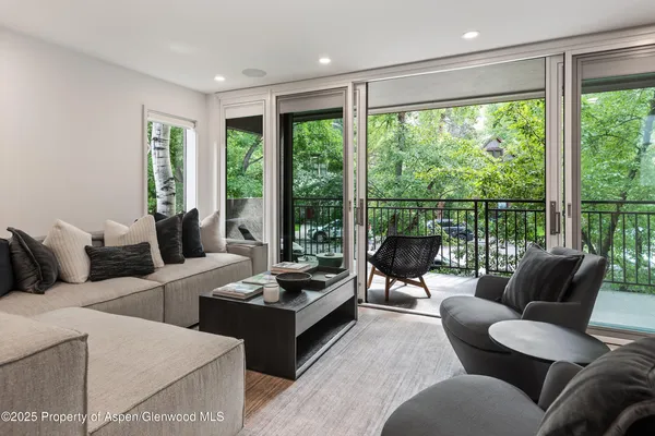 a living room with furniture and large windows