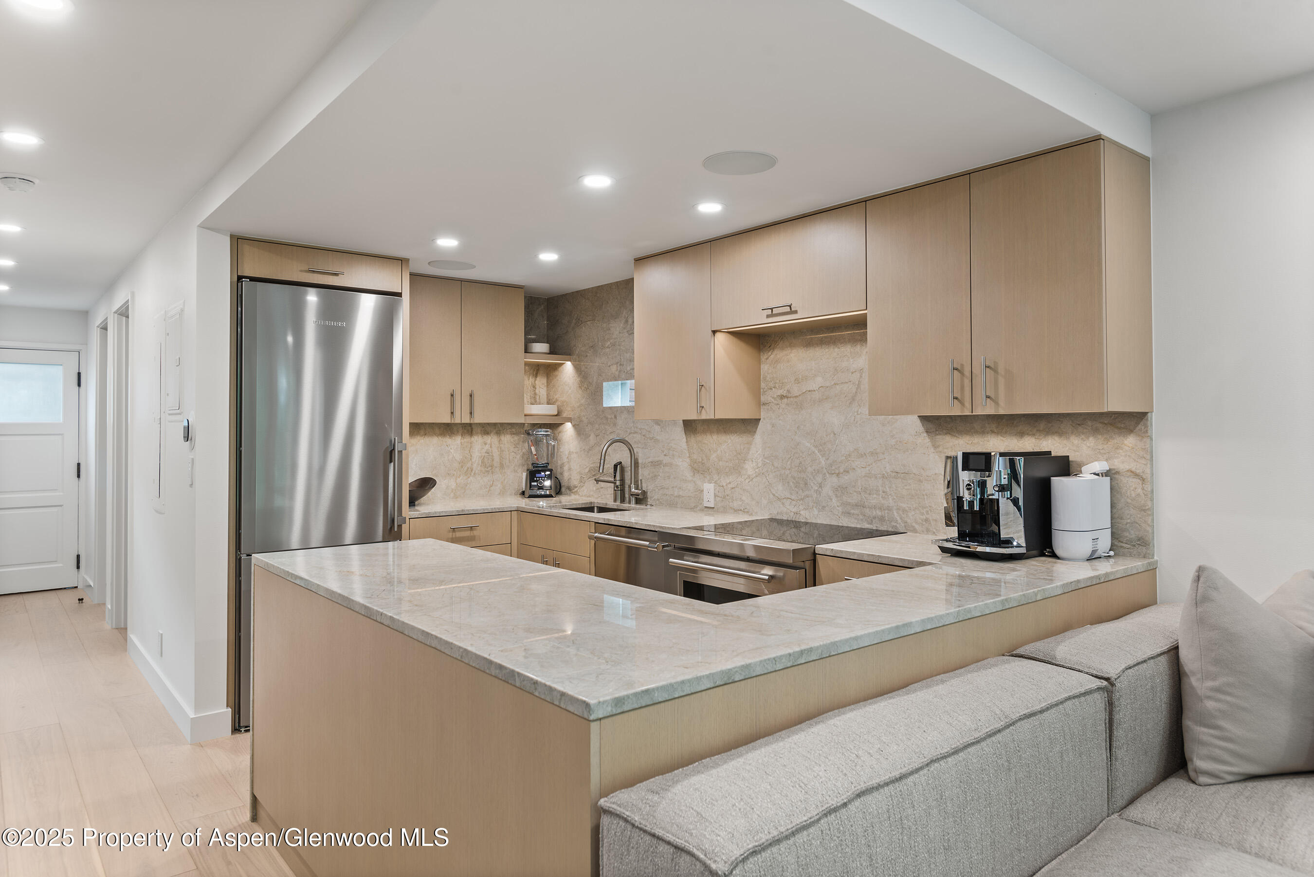 800 East Hopkins Avenue, Unit B5 Aspen, CO 81611 - Photo 5 of 29 a kitchen with refrigerator and cabinets