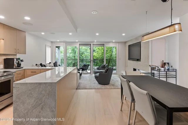 a large kitchen with kitchen island a large window in it