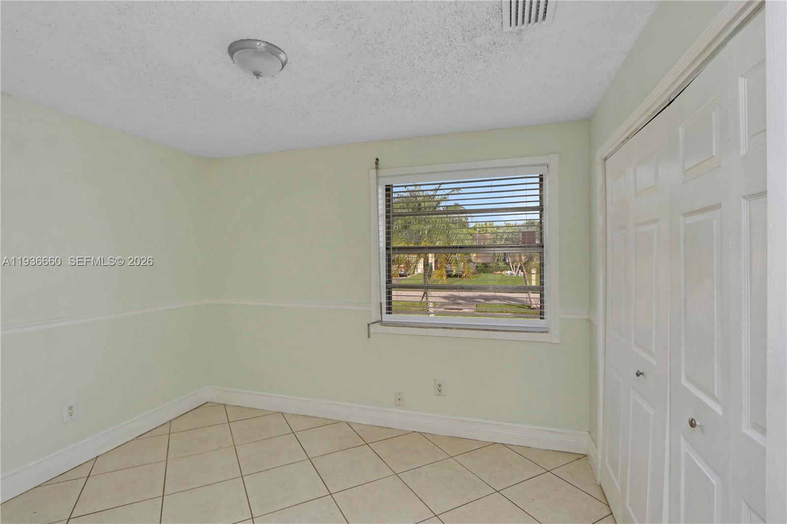 13254 Southwest 255th Terrace Homestead, FL 33032 - Photo 17 of 23 a view of an empty room with a window