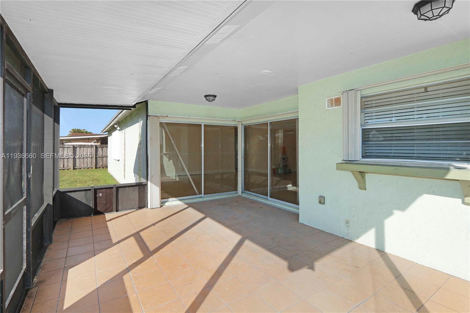 13254 Southwest 255th Terrace Homestead, FL 33032 - Photo 18 of 23 a bedroom with a bed and a window
