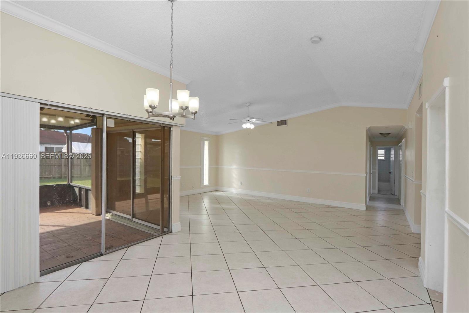 13254 Southwest 255th Terrace Homestead, FL 33032 - Photo 5 of 23 a view of a livingroom with a chandelier fan and windows