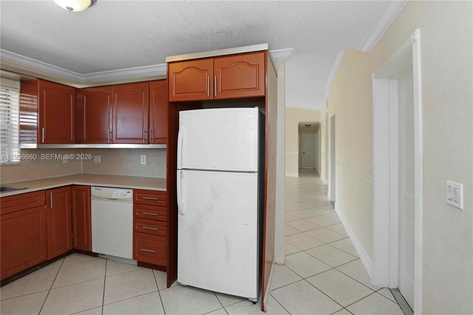 13254 Southwest 255th Terrace Homestead, FL 33032 - Photo 8 of 23 a kitchen with a refrigerator and cabinets