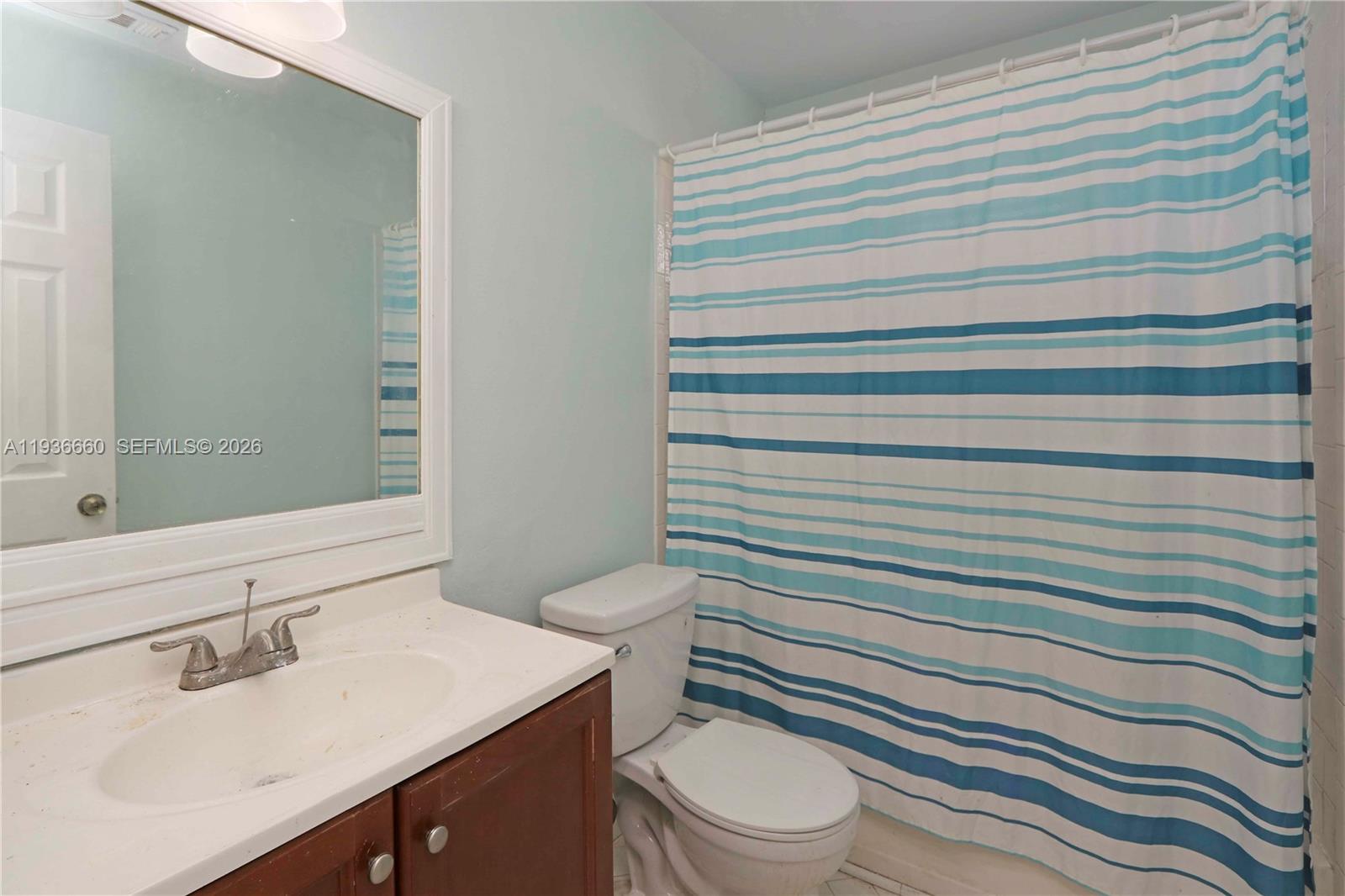 13254 Southwest 255th Terrace Homestead, FL 33032 - Photo 10 of 23 a bathroom with a sink toilet and mirror