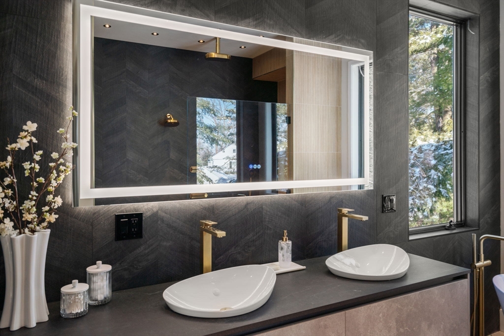 53 Countryside Road, Unit 53 Newton, MA 02459 - Photo 30 of 40 a bathroom with a granite countertop sink and a mirror