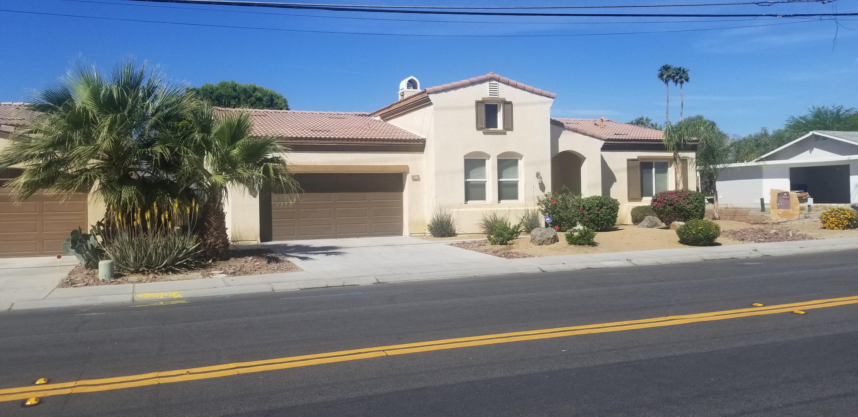 42375 Warner Trail Palm Desert, CA 92211 - Photo 1 of 33 a front view of a house with a yard and garage