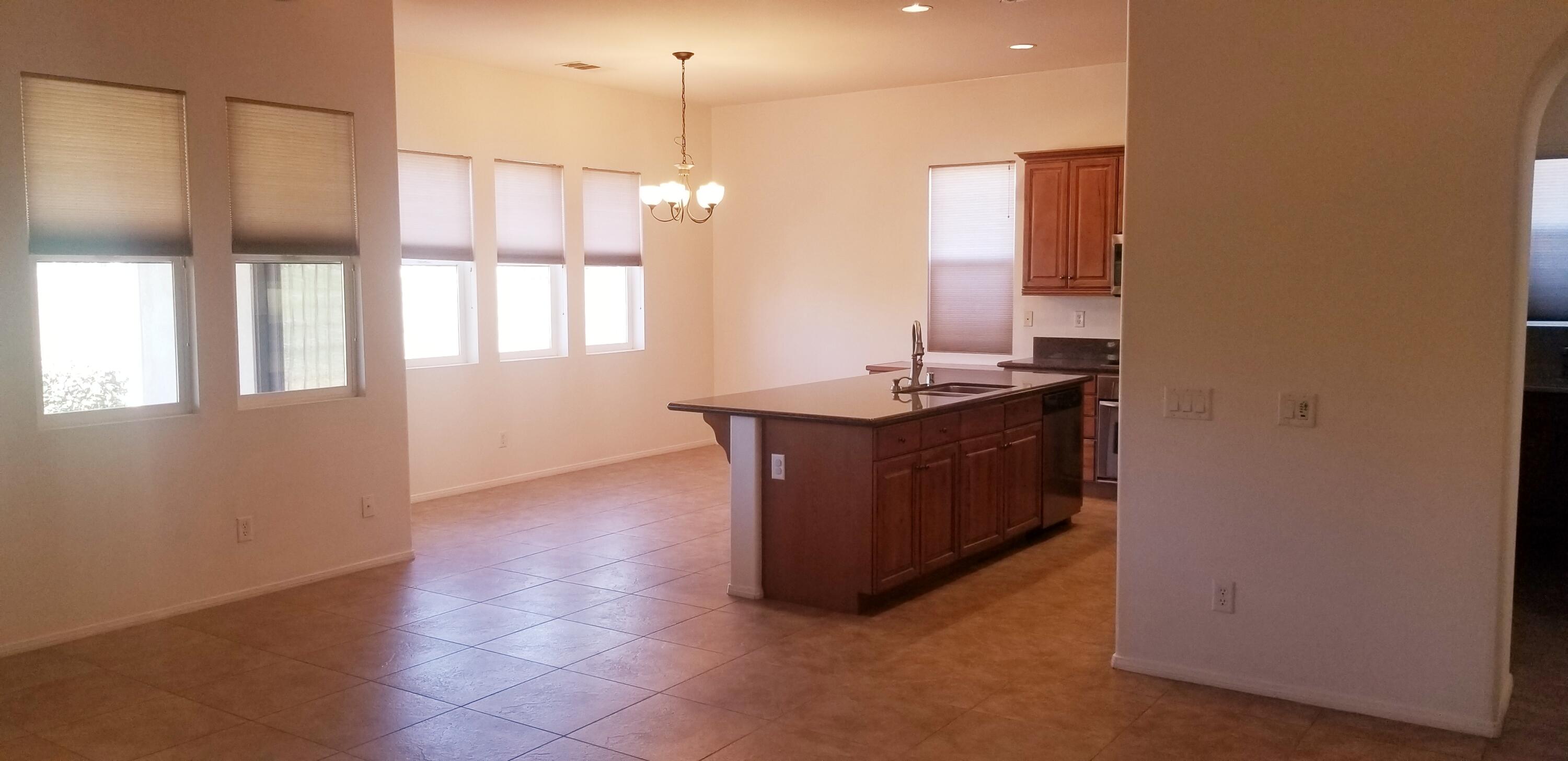 42375 Warner Trail Palm Desert, CA 92211 - Photo 4 of 33 a kitchen with stainless steel appliances granite countertop a sink a stove and a wooden floor
