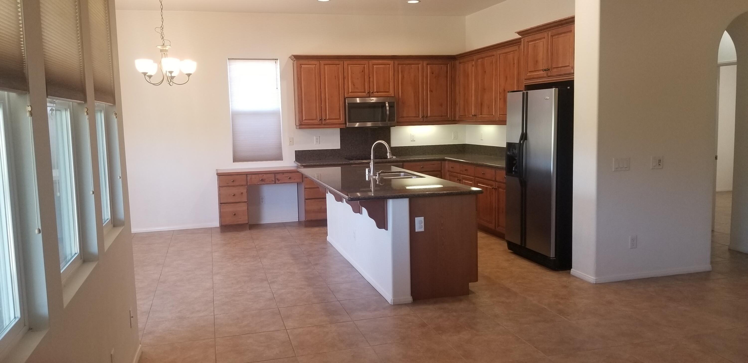 42375 Warner Trail Palm Desert, CA 92211 - Photo 5 of 33 a kitchen with stainless steel appliances granite countertop a sink and a refrigerator