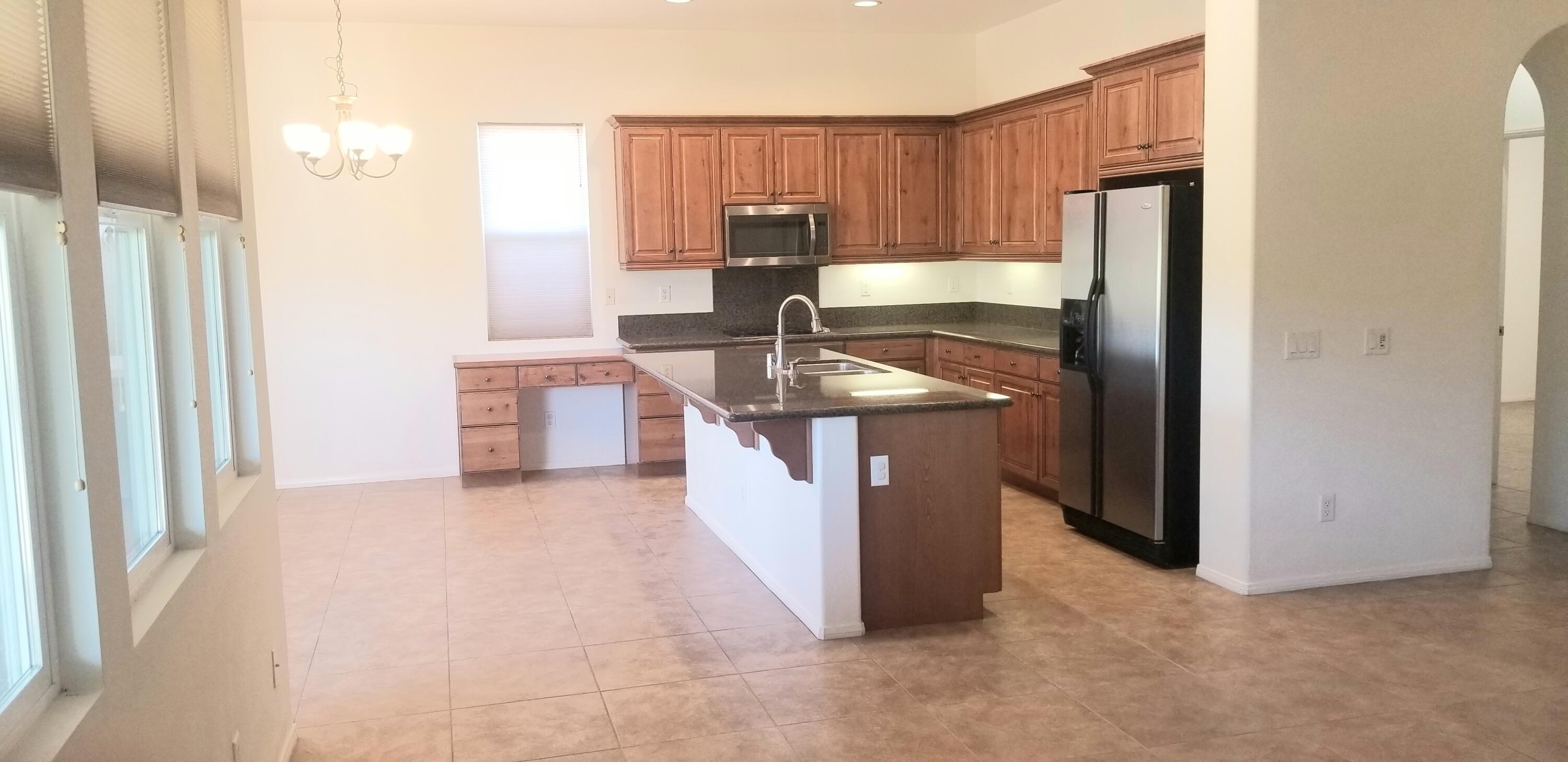42375 Warner Trail Palm Desert, CA 92211 - Photo 6 of 33 a kitchen with stainless steel appliances granite countertop a sink and a refrigerator