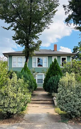 a view of house with yard and tree s