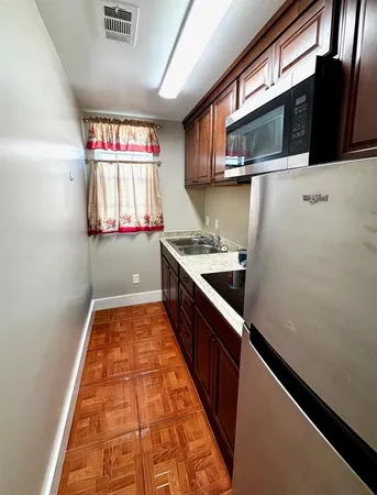 a kitchen with stainless steel appliances granite countertop a sink and a microwave