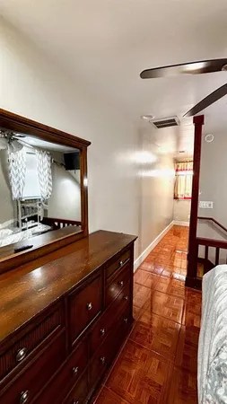 a bedroom with a bed and a mirror