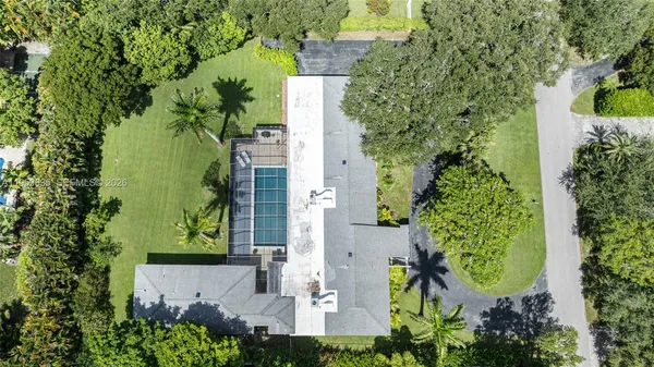an aerial view of a residential houses with outdoor space