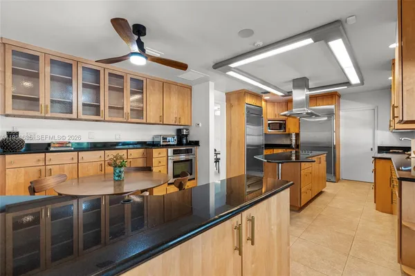 a kitchen with stainless steel appliances granite countertop a refrigerator and stove