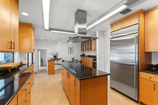 a kitchen with stainless steel appliances granite countertop a sink a stove and a refrigerator