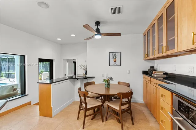 a kitchen with stainless steel appliances kitchen island granite countertop a sink and cabinets