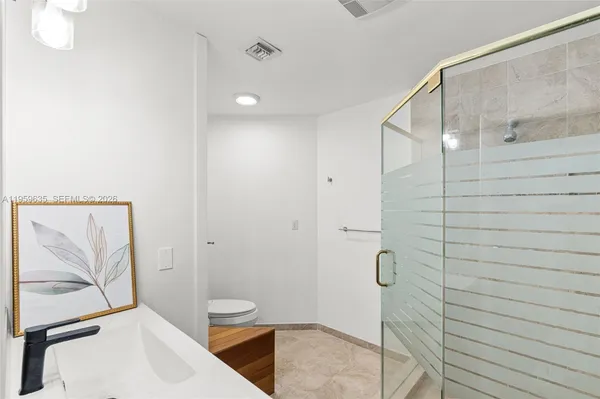 a bathroom with a sink and shower