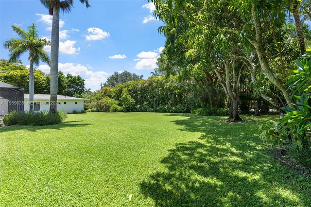 a house view with swimming pool in front of it