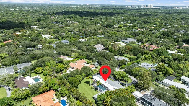a large bedroom with a large bed and wooden floor