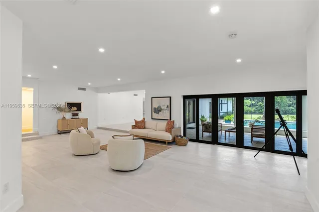 a living room with furniture and large windows