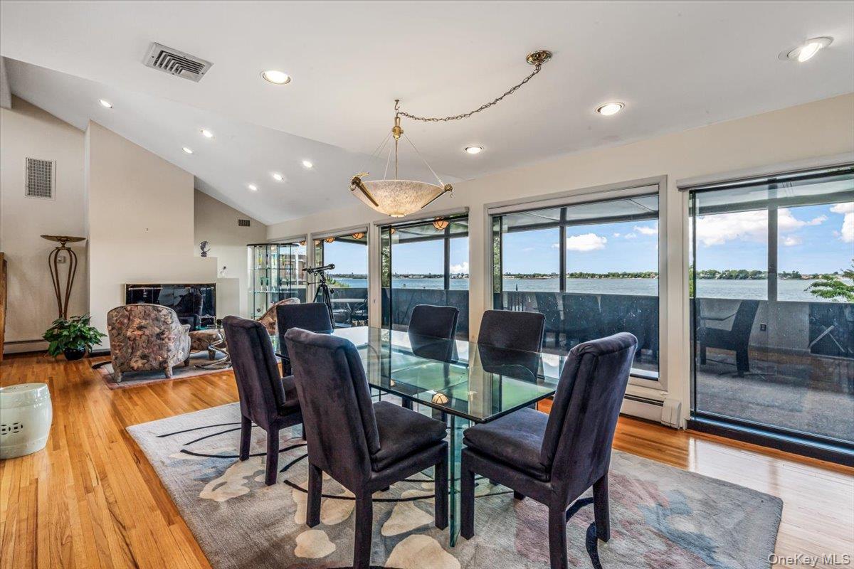 154-43 Riverside Drive Queens, NY 11357 - Photo 15 of 41 a view of a dining room with furniture large windows and wooden floor